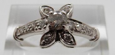An 18ct gold ring set with diamonds in a floral cluster, the largest approximately 0.