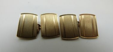 A pair of 9ct gold cufflinks with engine turned design,