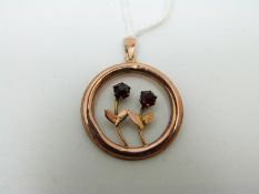 A 9ct gold Edwardian pendant set with two garnets
