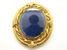 A large Victorian swivel brooch with twisted rope border and engraved foliate design