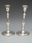 A pair of Georgian hallmarked silver candlesticks of baluster form with engraved crest to both base