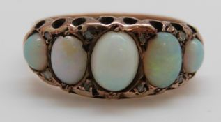 A 9ct gold ring set with five graduated opal cabochons and diamonds, Birmingham 1916, size P,