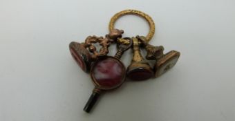 Three Victorian seals/ ingots set with agate and a watch key