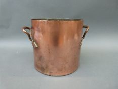 A 19thC twin-handled copper saucepan,