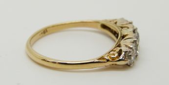 An 18ct gold ring set with five graduated diamonds, the centre stone approximately 0.