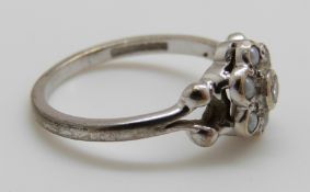 A 9ct white gold ring set with a diamond and seed pearls, 2.