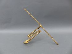 A brass articulated tapestry / fire screen frame