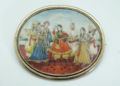 A miniature portrait brooch hand painted with an Indian dancing scene,