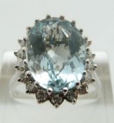 An 18ct white gold ring set with a central oval mixed cut aquamarine of approximately 2ct in a