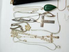 A collection of silver jewellery to include crosses, garnet and pearl necklaces, silver chains,