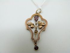 A 9ct gold Edwardian pendant set with two garnets