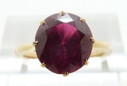 A yellow metal ring set with a synthetic ruby, size L, 2.