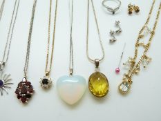 A collection of silver jewellery to include tiger's eye earrings and pendant, two silver rings,