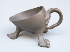 A pewter pipe rest numbered 21728