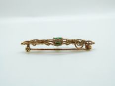 A 9ct gold brooch set with an oval cut emerald measuring approximately 0.75ct, 4.