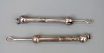 Two dumbell shaped hallmarked silver retractable button hooks