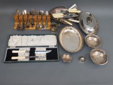 A collection of plated ware including a cased Garrard carving set, pair of pierced bon bon dishes,