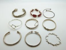 Seven silver bangles and two silver bracelets