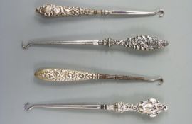 Four various hallmarked silver handled button hooks