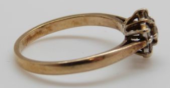 A 9ct gold ring set with diamonds in a cluster (size L)