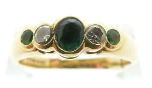 An 18ct gold ring set with three emeralds and diamonds, size T/U, 5.