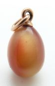 A sunstone egg pendant with a yellow metal fitting,