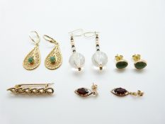 A pair of 14k gold earrings set with an emerald cabochon to each (4.