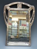 A Spanish white metal or similar Art Nouveau bevelled glass mirror impressed marks including Menese