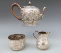 A Victorian Goldsmiths & Silversmiths Company hallmarked silver three piece bachelor's teaset with