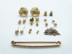 A 9ct gold bar brooch, a pair of 9ct gold earrings set with a diamond to each (3.
