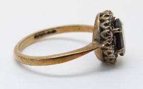 A 9ct gold ring set with a garnet and paste and a 9ct gold ring set with garnets in a cluster,