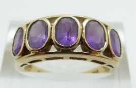 A 9ct gold ring set with five oval cut amethysts, size N, 3.