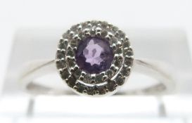 A 9ct white gold ring set with an amethyst and diamonds, size O, 2.