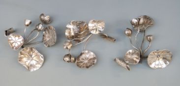 Three white metal flowers possibly nasturtiums, no visible marks,