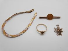 A 9ct gold ring set with tiger's eye, a 9ct gold tri-coloured bracelet,