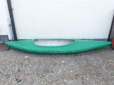 A fibreglass canoe with paddles,