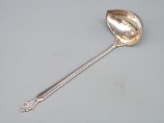 A Georg Jensen hallmarked silver sauce ladle with GI and 925 marks and also import marks for London