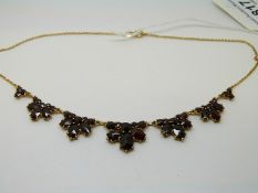A 10ct gold necklace set with Bohemian cut garnets in seven graduated garnitures