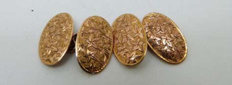 A pair of 9ct gold cufflinks with engraved ivy decoration,