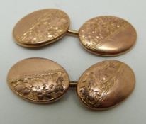 A pair of 9ct gold cufflinks with floral decoration,