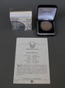 A 1925 Liberty peace dollar of the USA in a Coins of America case,