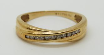 An 18ct white gold ring set with diamonds in a cross over setting, 2.