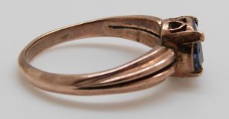 A yellow metal ring set with a sapphire, size L/M, 2.