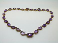 A Victorian necklace set with graduated oval cut amethysts, the largest approximately 8.