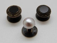 Three French silver studs, one set with a pearl and two set with onyx and marcasite,