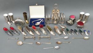 A quantity of silver plated pin cushions, many formed as shoes,
