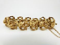 A late Victorian yellow metal bracelet in Art Nouveau design, each link depicting a daffodil,