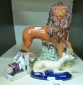 A 19thC Staffordshire model of a greyhound lying down with its front paws crossed, on a blue base,