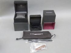 Three wristwatch boxes, a canvas military style watch strap,