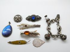 A white metal Eastern bracelet set with cabochons, a silver pendant set with butterfly wing,